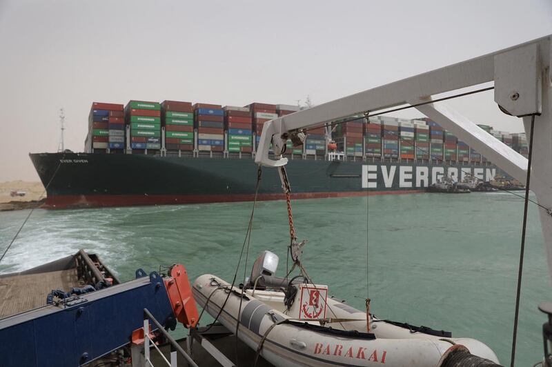 Egyptian tug boats try to free the ship. AFP