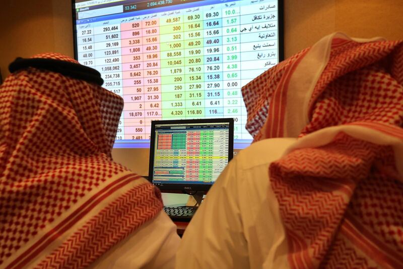 epa07094521 Saudi traders follow shares on screen at the stock market trading room in Riyadh, Saudi Arabia, 15 October 2018. Saudi Tadawul All-Share Index (TASI) on 15 October increased by 3.5 percent one day after the market suffered a 6.8-percent drop amid fears of imminent United States sanctions prompted by the disappearance of a Saudi journalist.  EPA/AHMED YOSRI