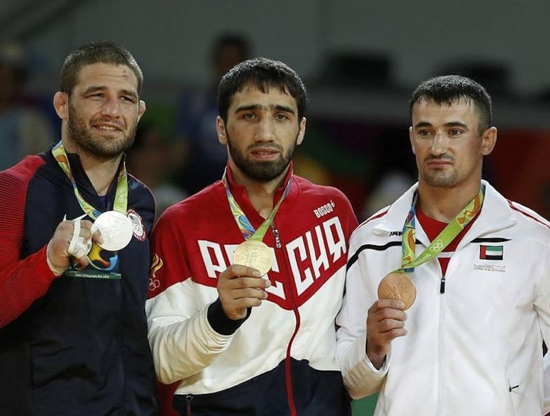 From left: US Travis Stevens (silver), Russia's Khasan Khalmurzaev (gold) and the UAE's Sergiu Toma (bronze) celebrate with their medals on the podium of the men's -81kg judo contest of the Rio 2016 Olympic Games in Rio de Janeiro on August 9, 2016. AFP / Jack GUEZ