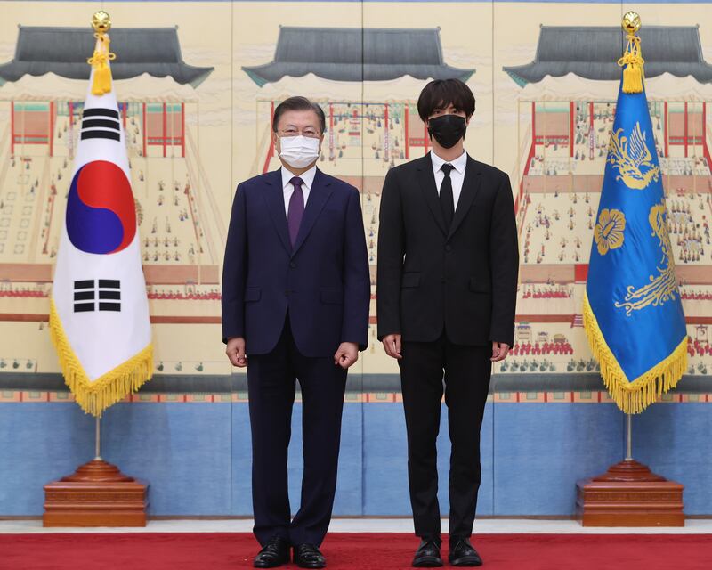 BTS member Jin with the South Korean president. EPA