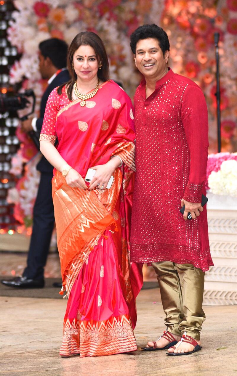 Former Indian cricket captain Sachin Tendulkar (R) and his wife Anjali arrive for the pre-engagement party on the Thursday night. AFP