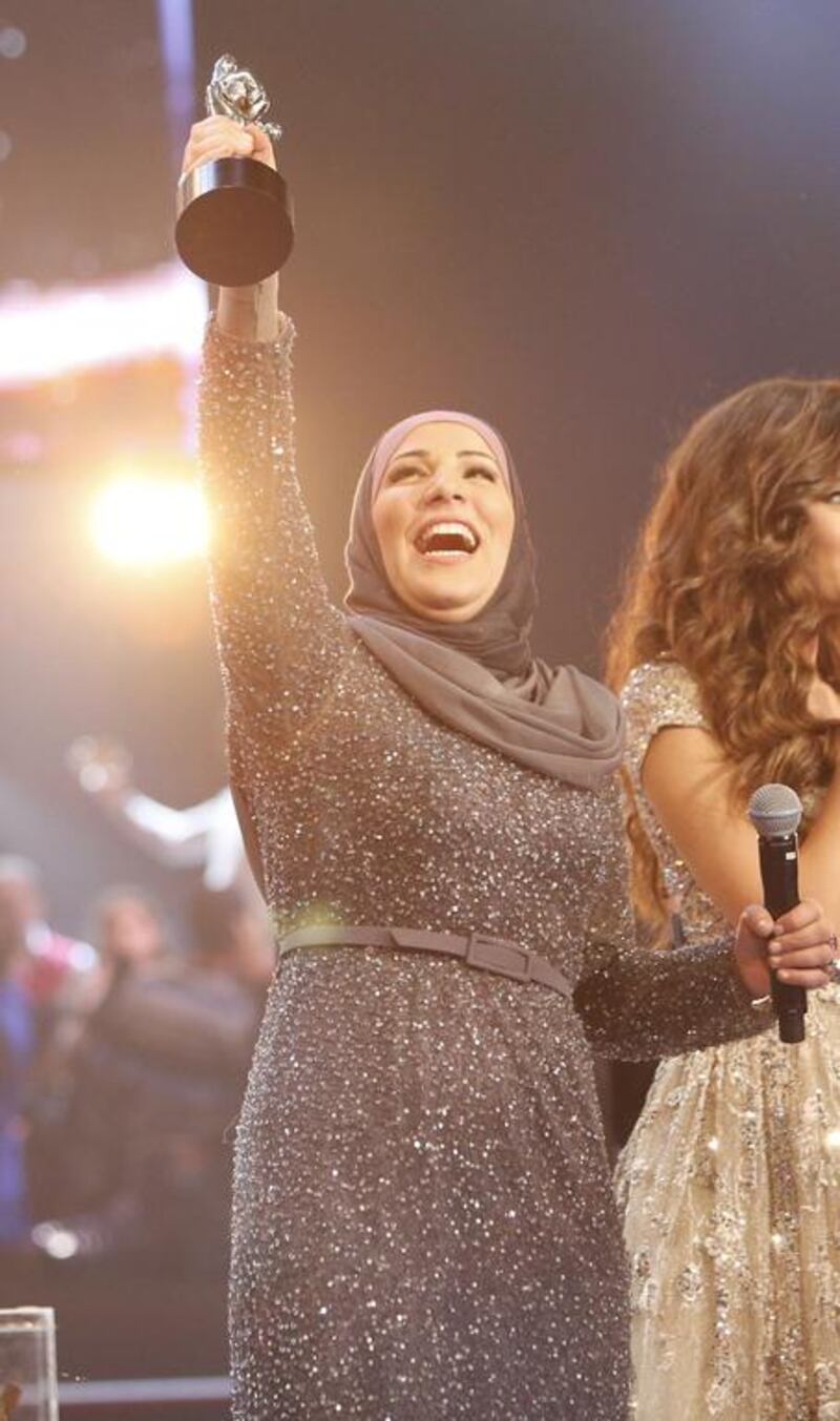 Nedaa Shrara holds her trophy aloft after being crowned the winner of The Voice Ahla Sawt. Courtesy MBC