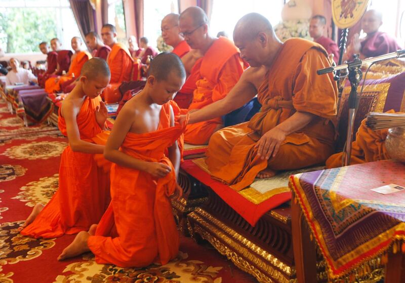 Members of Wild Boars mark the completion of their serving as novice Buddhist monks. AP Photo