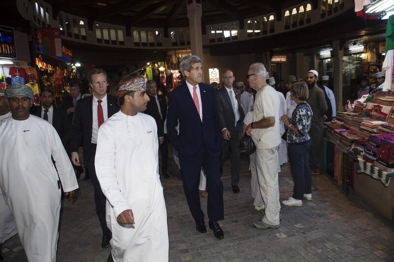 US Secretary of State John Kerry (C) visits the Mattrah souk in Muscat on November 10, 2014. Iran and the United States held a second day of talks today in Oman about a long hoped for nuclear deal, with key differences threatening to scupper a final agreement. Nicholas Kamm / AP