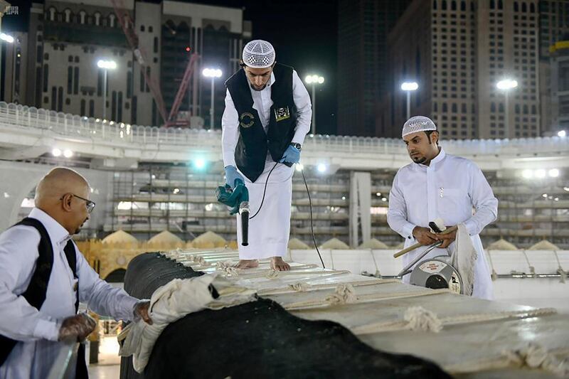 Workers clean and sterilise the roof of Kaaba at the Grand Mosque in Makkah, Saudi Arabia, amid the coronavirus pandemic on April 21, 2020. Saudi Press Agency via Reuters