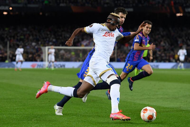 Napoli's forward Victor Osimhen, left, vies with Barcelona's defender Gerard Pique. AFP