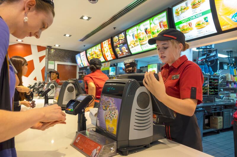 Australia, Sydney, CBD Central Business District Circular Quay McDonald's restaurant fast food counter customer ordering paying woman teen girl job employee cash register. (Photo by: Jeff Greenberg/UIG via Getty Images)