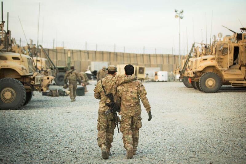 FILE PHOTO: A U.S. soldier from the 3rd Cavalry Regiment walks with the unit's Afghan interpreter before a mission near forward operating base Gamberi in the Laghman province of Afghanistan December 11, 2014. REUTERS/Lucas Jackson/File Photo