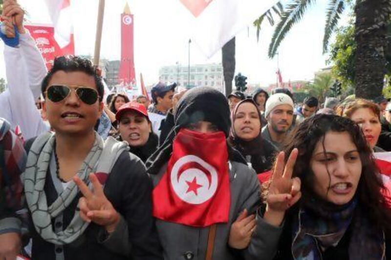Tunisians protest in Tunis on the second anniversary of the uprising that ousted president Zine El Abidine Ben Ali.