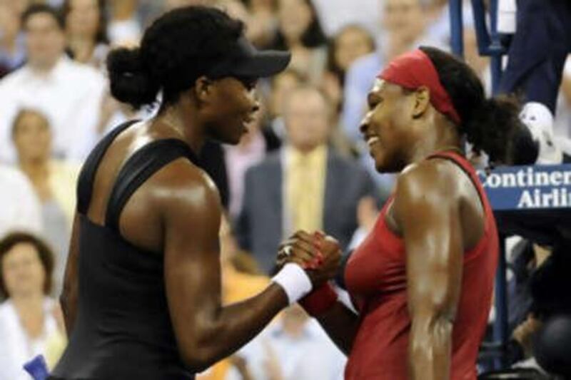 Serena Williams, right, embraces her sister Venus after defeating her in their US Open quarter-final match.