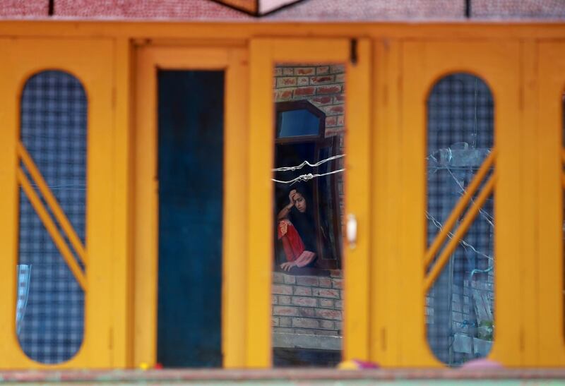A girl's reflection is seen in a mirror in  Kashmir. Farooq Khan / EPA