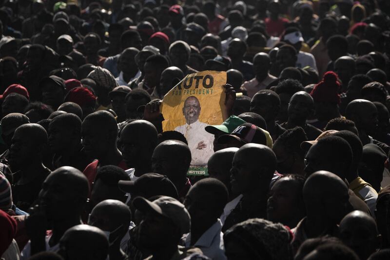 A supporter holds a poster of Kenya's Deputy President William Ruto during his first rally after being officially nominated as a presidential candidate in Nairobi. AFP