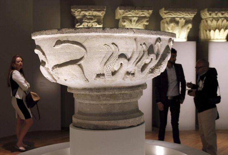 People looking at a ‘Bonifilius’ bassin made in northern Italy in the 12th century. Francois Guillot/AFP