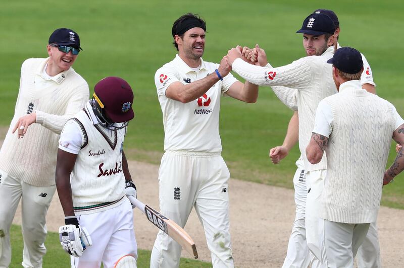 England's James Anderson, centre, celebrates with teammates after taking the wicket of West Indies' Shamarh Brooks. AFP