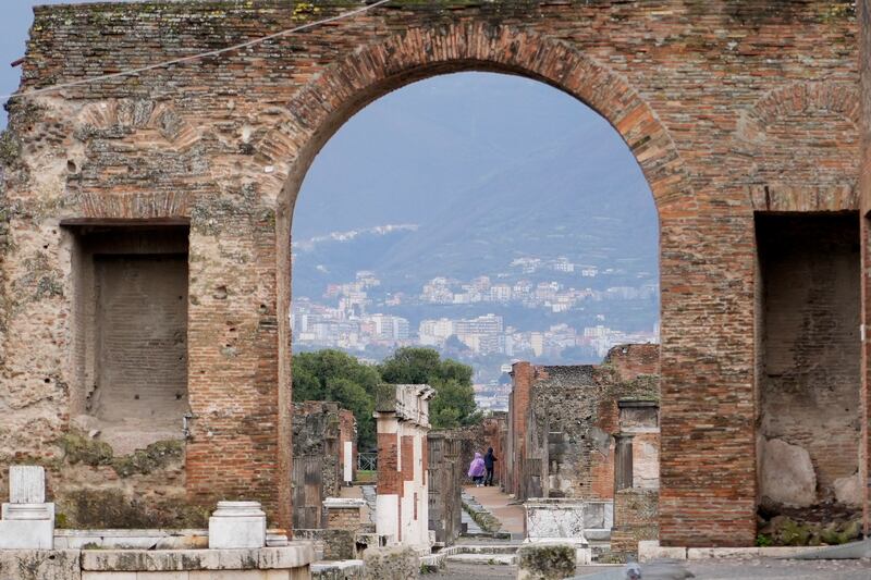A view of the Pompeii site through an archway.