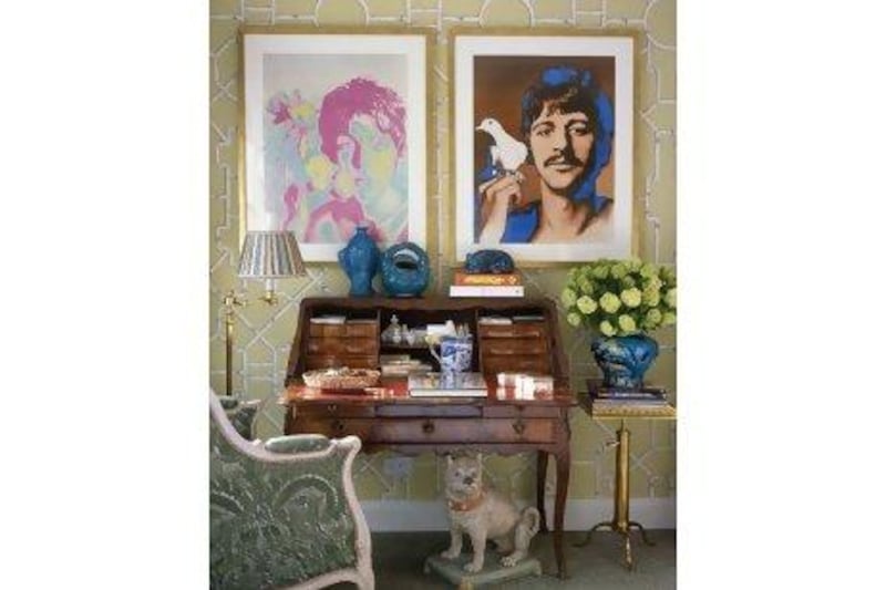 Vintage Beatles posters hang above an 18th century French desk to create a small, vibrant study area. Roger Davies / The Interior Archive