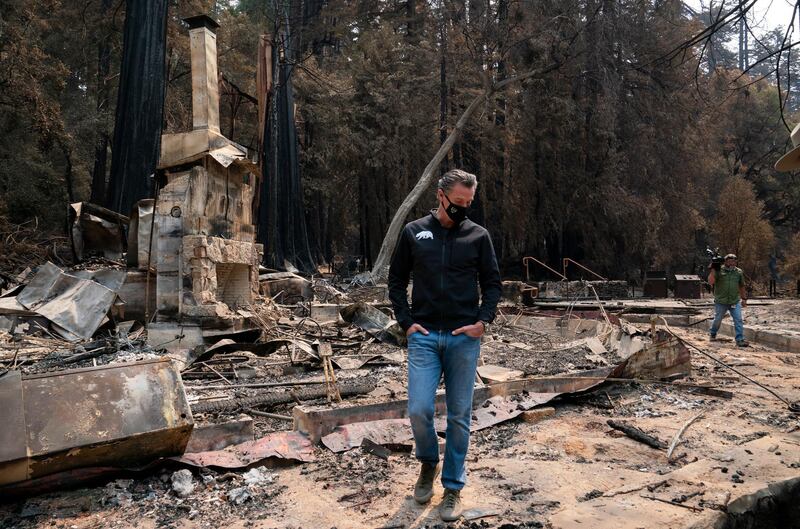 Gov. Gavin Newsom walks through the remnants of the headquarters building as he tours the fire damage to Big Basin Redwoods State Park, in Boulder Creek, California. AP