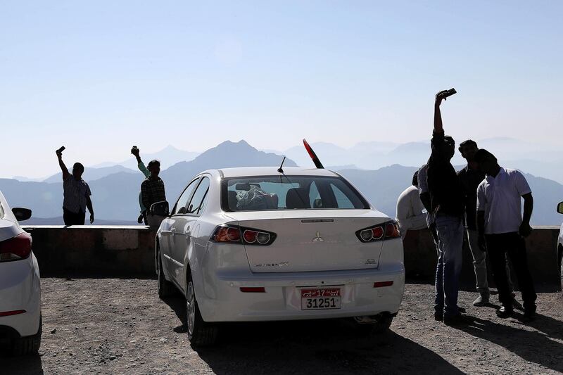 RAS AL KHAIMAH , UNITED ARAB EMIRATES , DEC 02  – 2017 :- People taking photos with their family and friends at the Jebel Jais mountain on the National Day in Ras Al Khaimah. Lot of them spent their night in the camping tent.  (Pawan Singh / The National) Story by Anna Zacharias