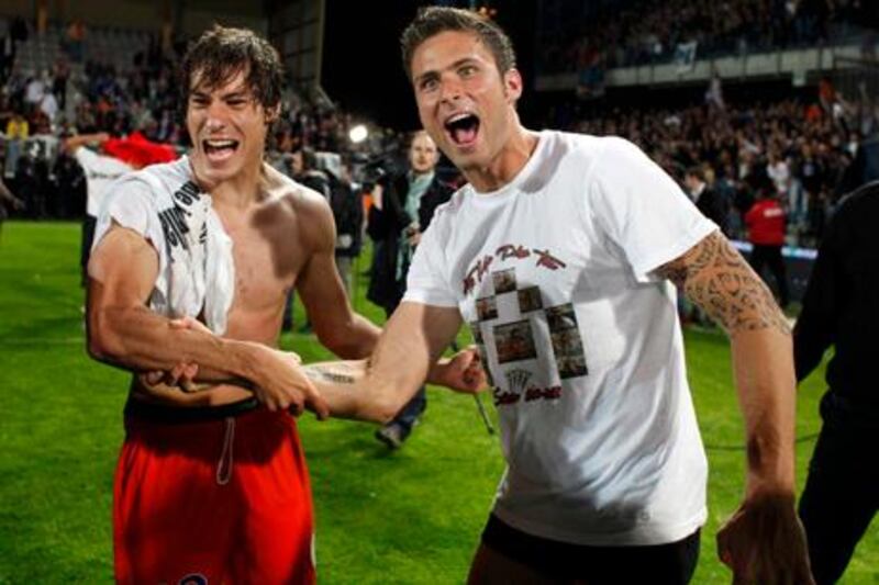 Montpellier's Benjamin Stambouli, left, and Olivier Giroud, right, celebrate after their French League one soccer match against Auxerre at the Abbe Deschamps stadium in Auxerre, central France, Sunday, May 20, 2012. Montpellier defeated Auxerre 2-1 and celebrated its first title. (AP Photo/Thibault Camus)