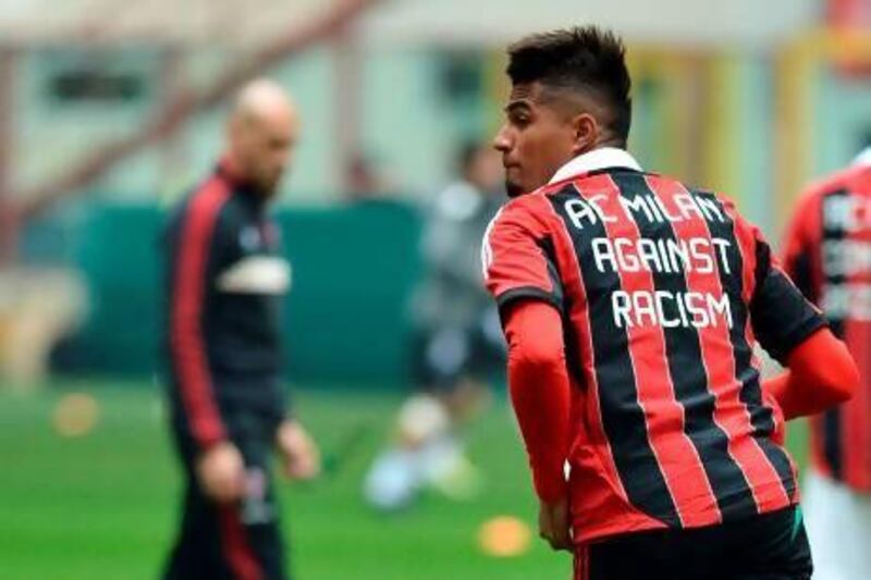 AC Milan's Kevin-Prince Boateng warms up, wearing a jersey protesting against racism earlier this season.