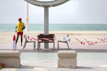 Lifeguards patrol an empty Jumeirah Beach in Dubai. Chris Whiteoak / The National
