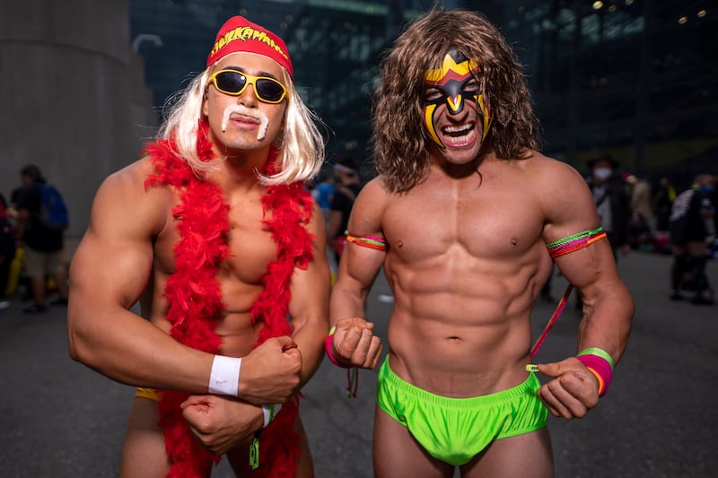 Attendees dressed as wrestlers Hulk Hogan and The Ultimate Warrior pose during New York Comic Con. Charles Sykes / Invision / AP