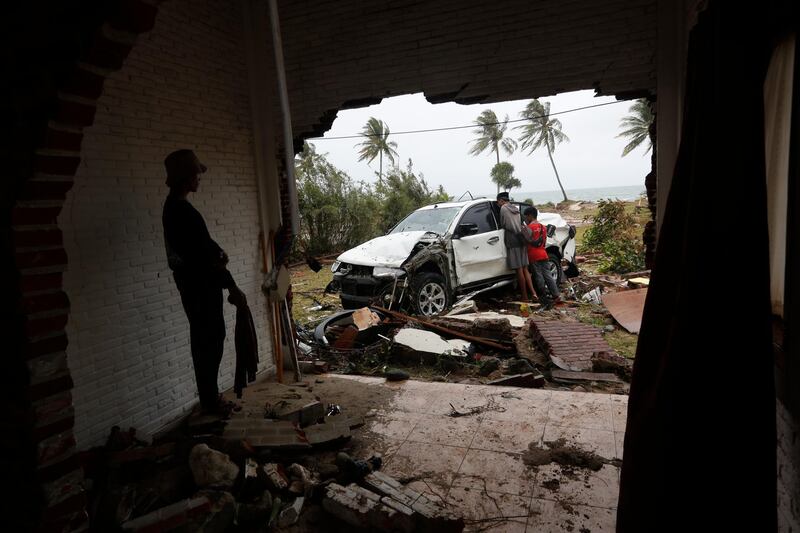 A cars sits among debris in Tanjung Lesung. EPA
