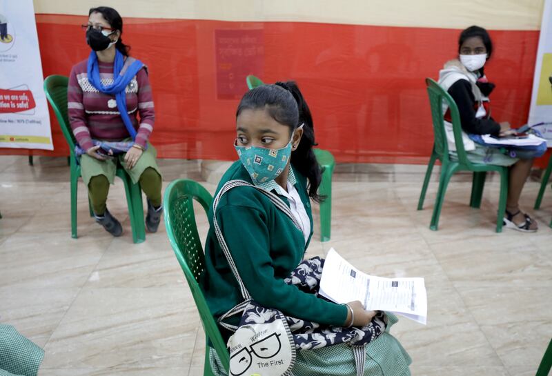Indian pupils visit their school for a Covid-19 vaccine dose in Kolkata. EPA