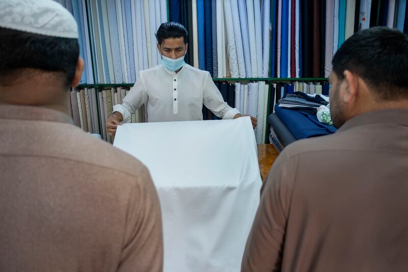 Customers choose fabrics for new clothes at Ghazal Al Madeena
