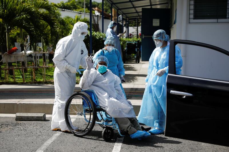 A woman is discharged after surviving Covid-19, at the San Rafael Hospital, in Santa Tecla, El Salvador. Reuters