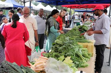 Customers check out the healthy goods on show at the farmers market in Business Bay. Pawan Singh/The National  