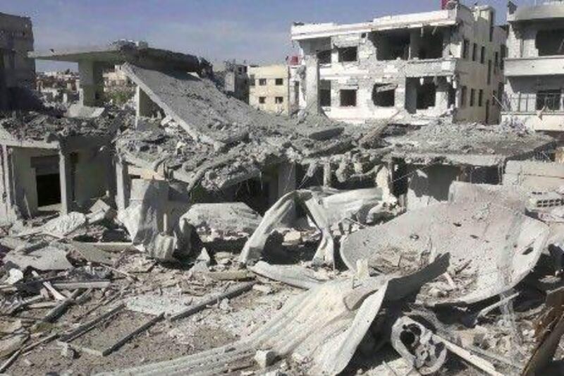 Buildings are damaged after a Syrian Air Force fighter jet fired missiles at Erbeen, near Damascus. Government jets carried out five strikes in the eastern Ghouta district, a rebel stronghold close to the capital, human rights activists say.