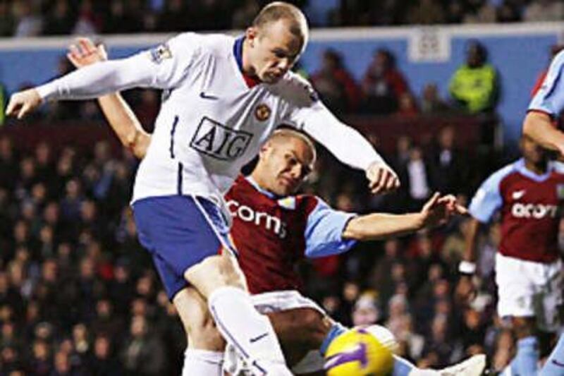 Wayne Rooney sees a shot blocked against Aston Villa.