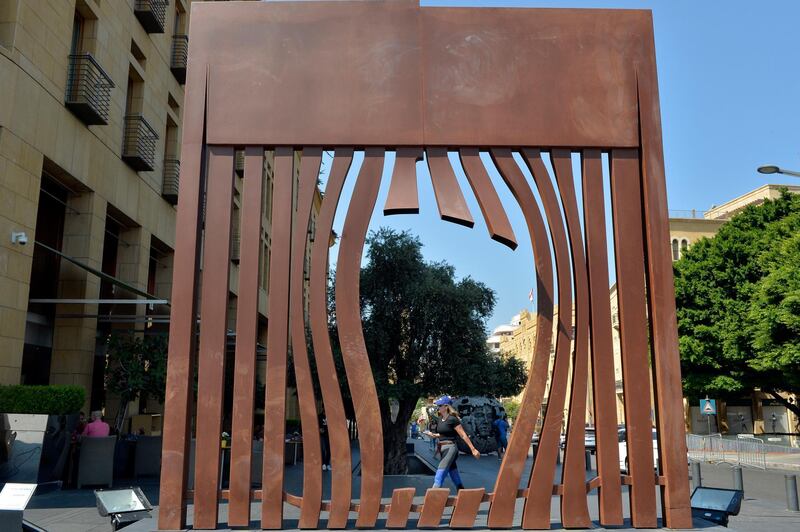 A woman walks past an artwork by Senegal artist Hady Sy called 'The Wall of Hope' at Beirut Art Week. EPA