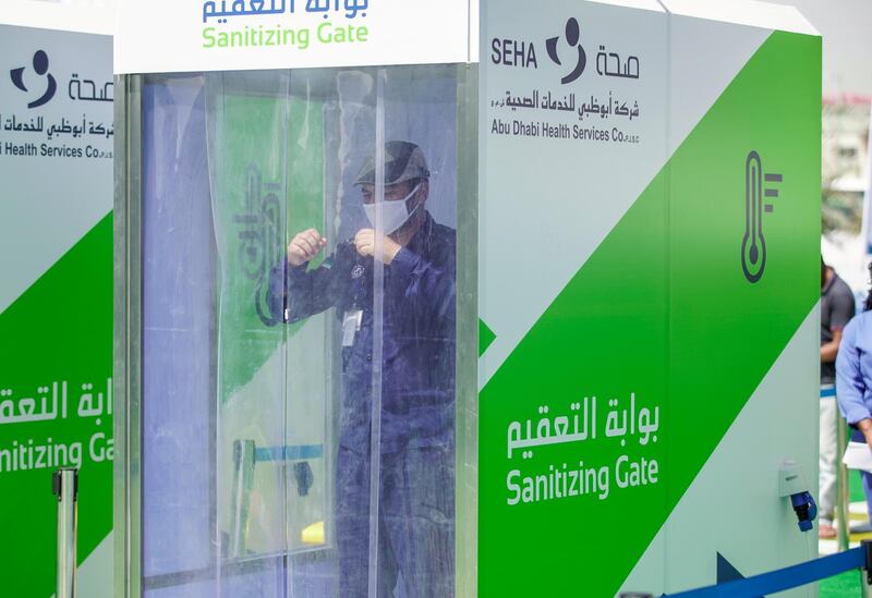 Abu Dhabi, United Arab Emirates, May 6, 2020. the new Ambulatory Healthcare Services, a SEHA Health System Facility, National Screening Project in Mussafah Industrial Area in Abu Dhabi.   -- A worker enters the Sanitising Gate before before entering the main tent screening center.
Victor Besa / The National
Section:  NA
Reporter:  Nick Webster