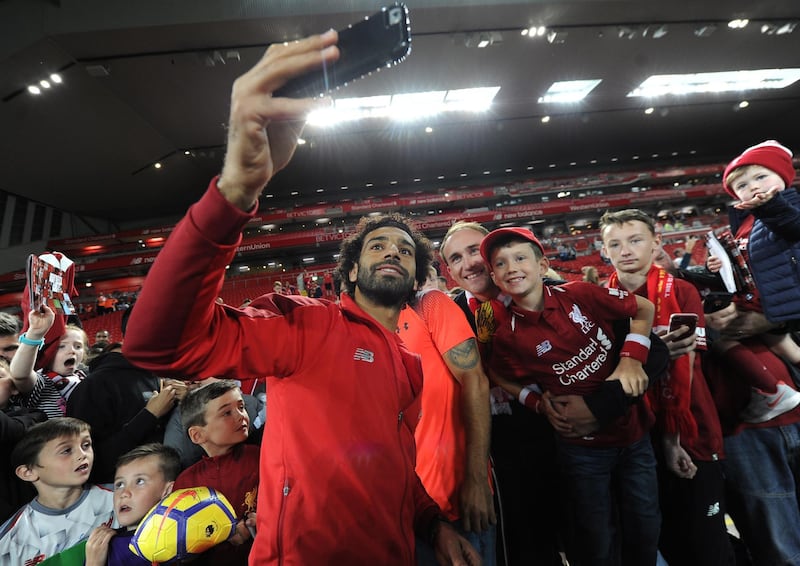 epa06933962 Liverpool's Mohamed Salah poses for photographs and signs autographs after a friendly soccer match between Liverpool and Torino held at Anfield , Liverpool, Britain, 07 August 2018.  EPA/PETER POWELL