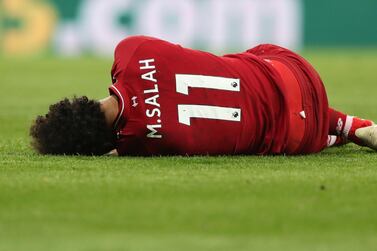 Liverpool's Mohamed Salah lays on the pitch after sustaining an injury against Newcastle United on Saturday. Reuters