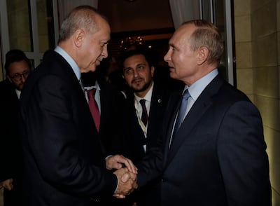 Russian President Vladimir Putin, right, and Turkish President Recep Tayyip Erdogan speak before Erdogan left the Bocharov Ruchei residence in the Black Sea resort of Sochi, Russia, Tuesday, Oct. 22, 2019. Erdogan says Turkey and Russia have reached a deal in which Syrian Kurdish fighters will move 30 kilometers (18 miles) away from a border area in northeast Syria within 150 hours. (Presidential Press Service via AP, Pool )