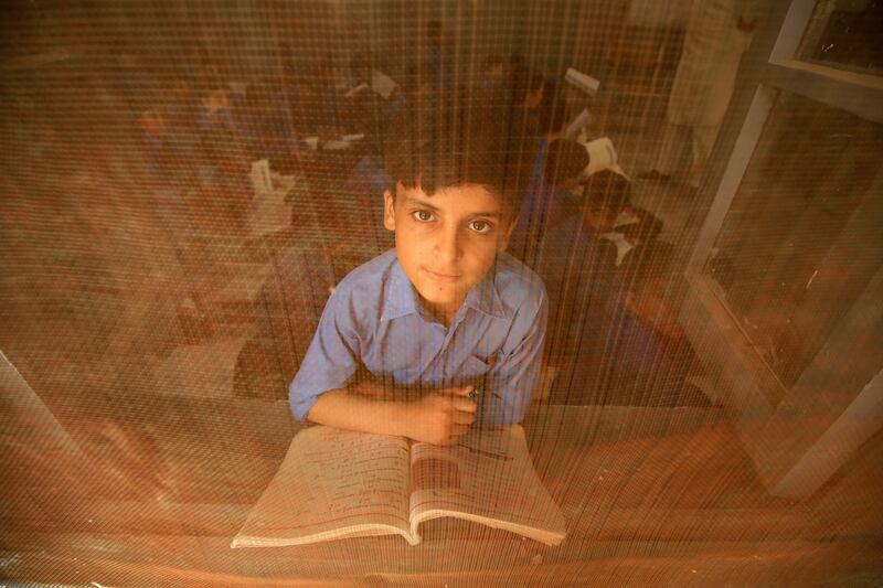 A Pakistani boy attends a class on International Literacy Day in Peshawar on Friday. EPA