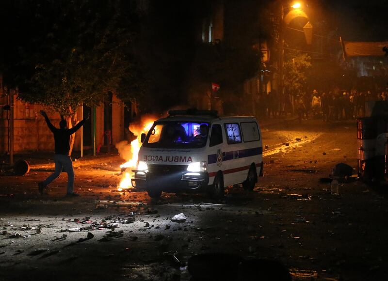 An ambulance arrives on the scene of a protest against the newly appointed Lebanese prime Minister Hassan Diab, at Corniche Al-Mazraa neighborhood in Beirut, Lebanon.  EPA