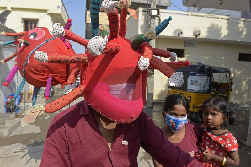 A health worker wears coronavirus-themed headgear in Hyderabad, India. AFP