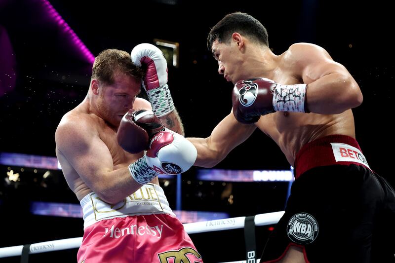 Dmitry Bivol throws a right at Canelo Alvarez during their WBA light heavyweight title fight at T-Mobile Arena.