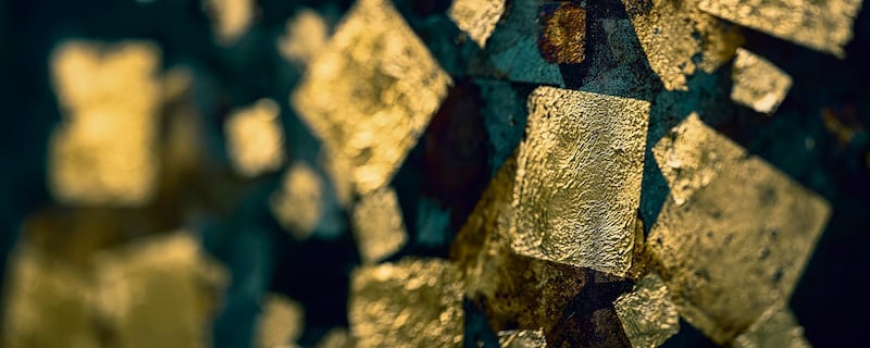 Abstract textured background of gold leaf square shapes on a grungy old rusty weathered metal background. Getty Images
