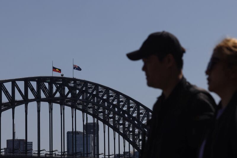 The separate Australian and Aboriginal flags are flown at half-mast on the Sydney Harbour Bridge on September 12, 2022, four days after Britain's Queen Elizabeth II died. Reuters