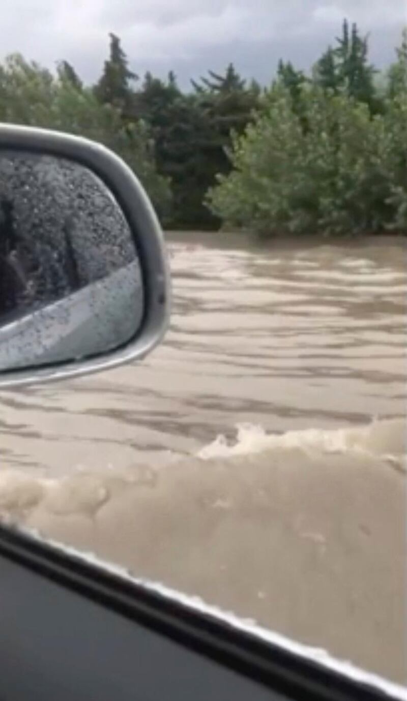 In this image from video, flash floods send a torrent of water down a street in Aubagne, France on Thursday, Aug. 9, 2018. Hundreds of rescuers backed by helicopters evacuated about 1,600 people, most of them campers, in three regions of southern France where heavy rain caused flash flooding and transformed rivers and streams into torrents, the interior minister said Thursday. (StÃ©phane Decoux via AP)