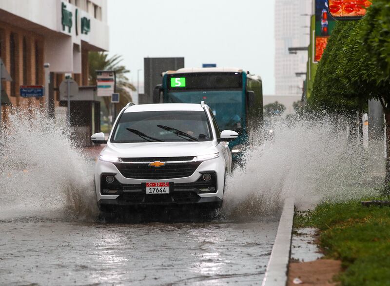 A car drives through a flooded road in central Abu Dhabi as a thunderstorm hit the UAE. Victor Besa / The National