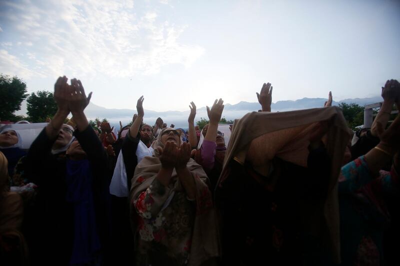 Kashmiri Muslims raise their hands in prayer in Srinagar. AP Photo