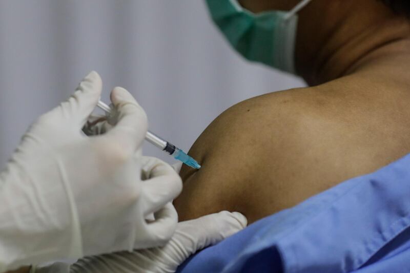 A healthcare worker injects a dose of the Sinopharm vaccine during the first day of a private vaccination drive for workers at Indah Kiat Pulp and Paper Company, on the outskirts of Jakarta, Indonesia. EPA