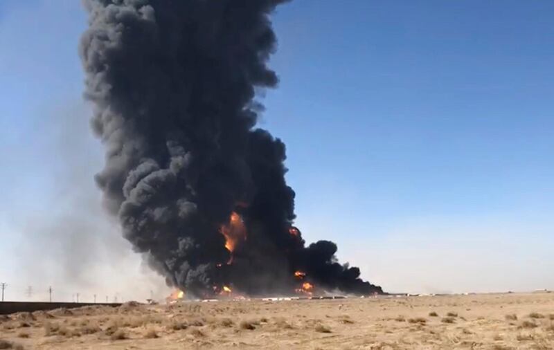 In this still image taken from video, smoke rises from fuel tankers at the Islam Qala border with Iran, in Herat Province, west of Kabul, Afghanistan. A fuel tanker exploded Saturday at the Islam Qala crossing in Afghanistan's western Herat province on the Iranian border, injuring at least seven people and causing a massive fire that consumed more than 500 trucks carrying natural gas and fuel, according to Afghan officials and Iranian state media. AP