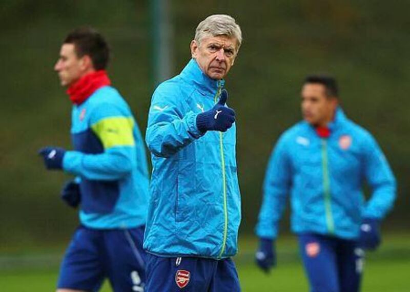 Arsene Wenger manager of Arsenal gives a thumbs up during an Arsenal training session, ahead of the UEFA Champions League Group D match against Borussia Dortmund, at London Colney on November 25, 2014 in St Albans, England. (Photo by Ian Walton/Getty Images)